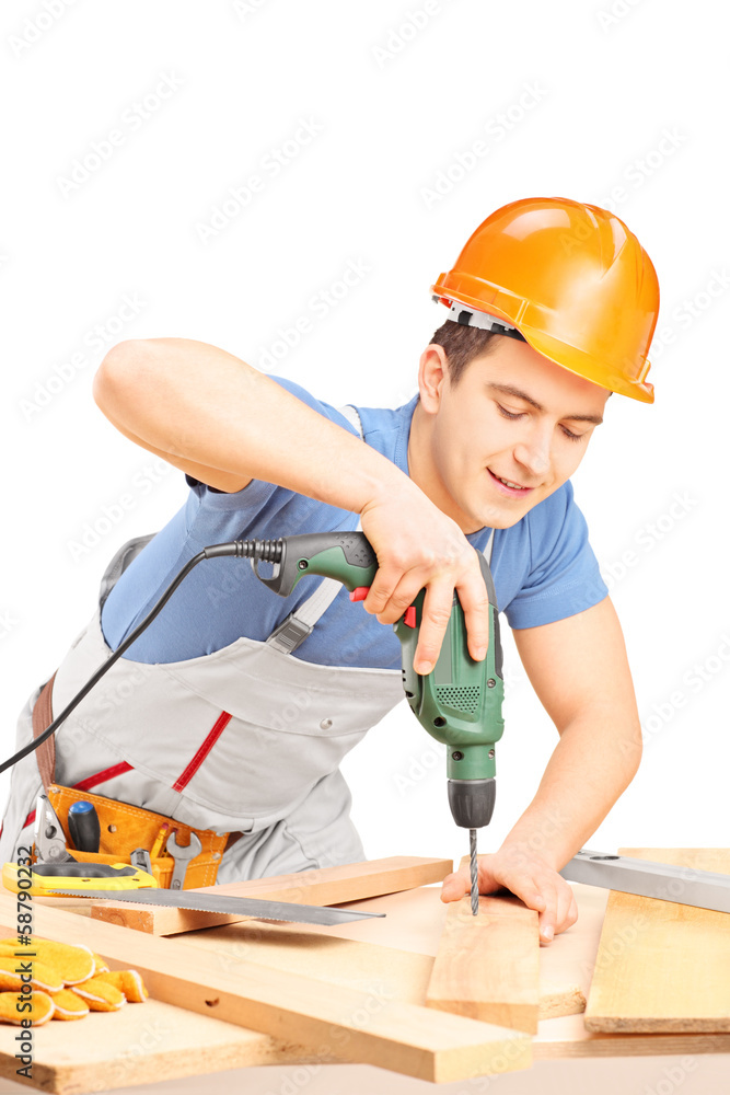 Manual worker drilling with a drilling machine in a workshop Manual worker drilling with a drilling machine in a workshop