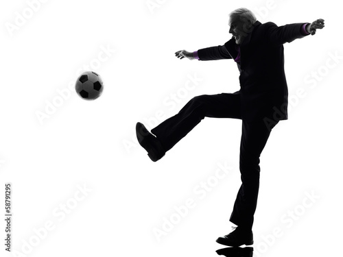 senior business man playing soccer silhouette