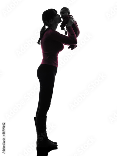 woman mother holding kissing baby silhouette