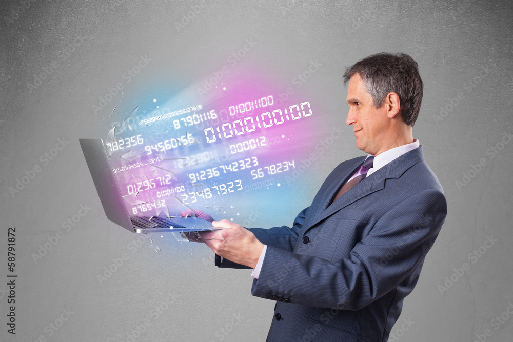 Businessman holding notebook with exploding data and numbers Businessman holding notebook with exploding data and numbers