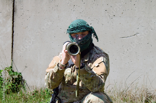 The terrorist masked man with a gun photo