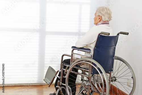 Lonely senior woman in wheelchair photo
