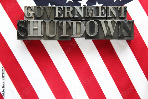 USA flag with government shutdown words in metal type photo