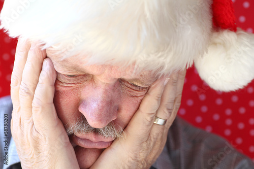 man looks sad in Santa hat photo