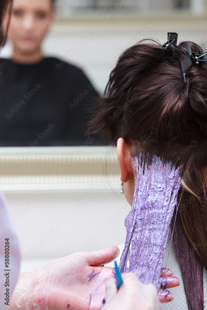 Naklejka premium hairdresser applying color female customer salon