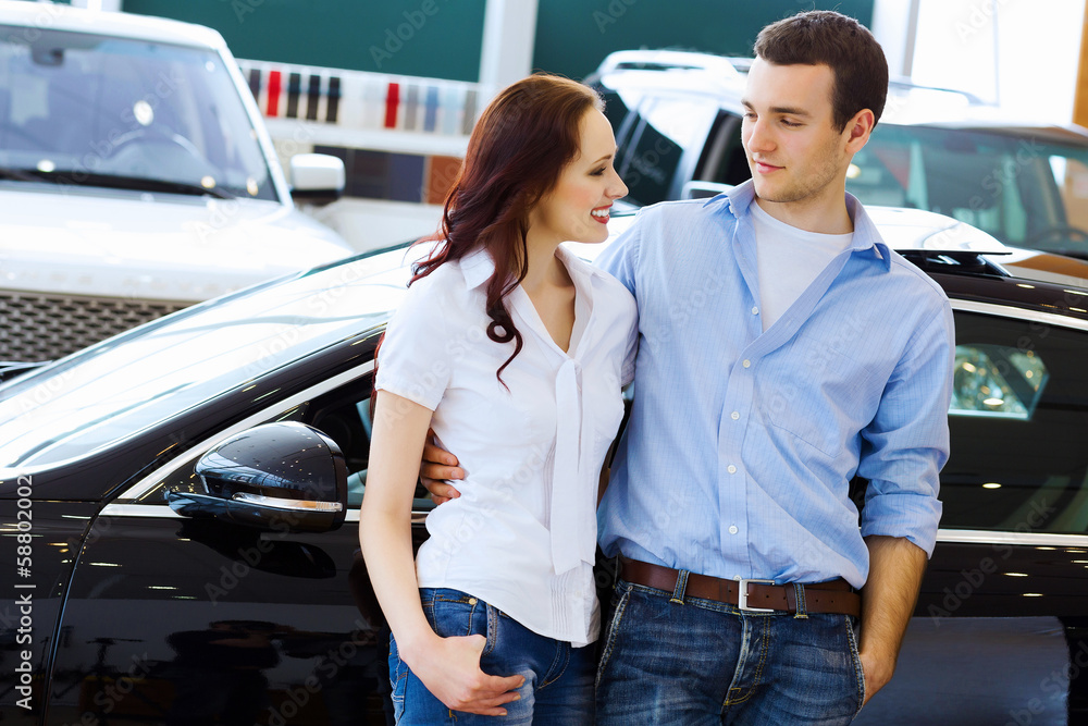 Young happy couple at car salon Young happy couple at car salon