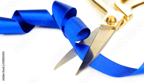 Fotografie Satin ribbon curled around scissors isolated on white