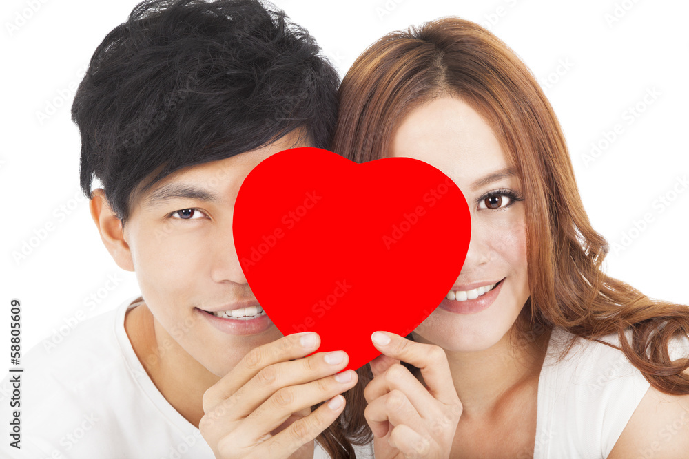 smiling couple holding the love sign smiling couple holding the love sign