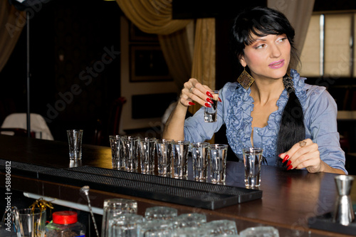 Obraz na płótnie Woman drinking vodka shots at a bar w salonie