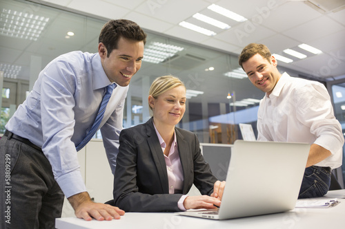 A business team of three in office and planning work