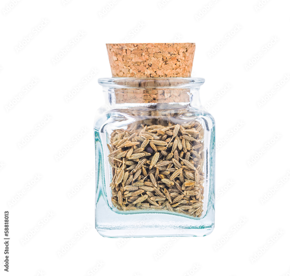 White cumin spice or Cuminum cyminum in a glass bottle