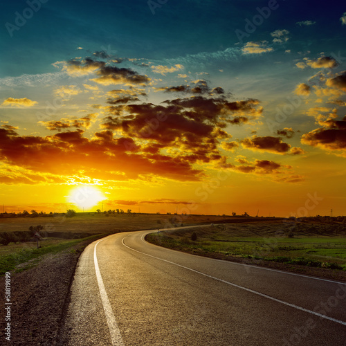 low orange sun over asphalt road