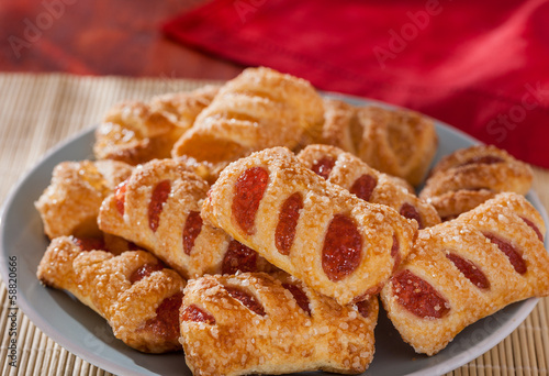 Strawberry and apple filled sugar coated puff pastry cakes close