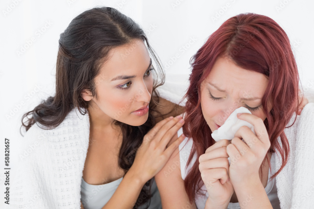 Young woman consoling a crying female friend Young woman consoling a crying female friend