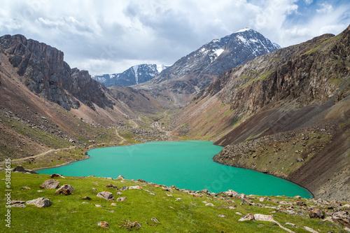 Turquoise wonderful lake in mountains of Tien Shan photo