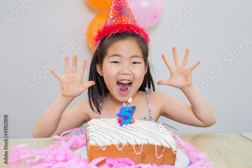 Cheerful little girl at her birthday party