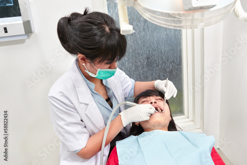 Dentist examing teeth