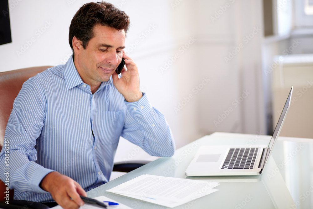 Attractive businessman talking on his cellphone Attractive businessman talking on his cellphone