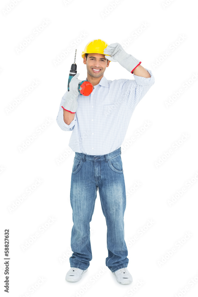 Smiling handsome young handyman in hard had with drill Smiling handsome young handyman in hard had with drill