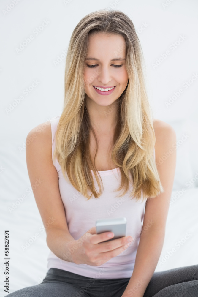 Beautiful smiling woman text messaging in bed Beautiful smiling woman text messaging in bed