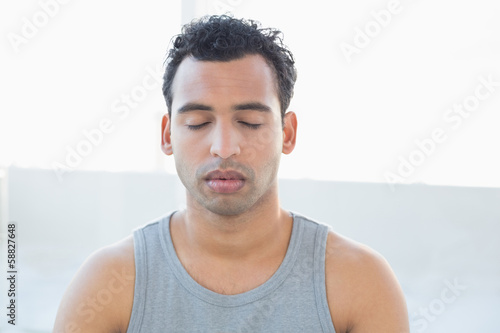 Close-up of a young man meditating with eyes closed