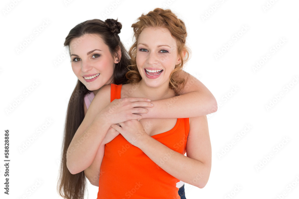 Portrait of a young female embracing her cheerful friend from be Portrait of a young female embracing her cheerful friend from be