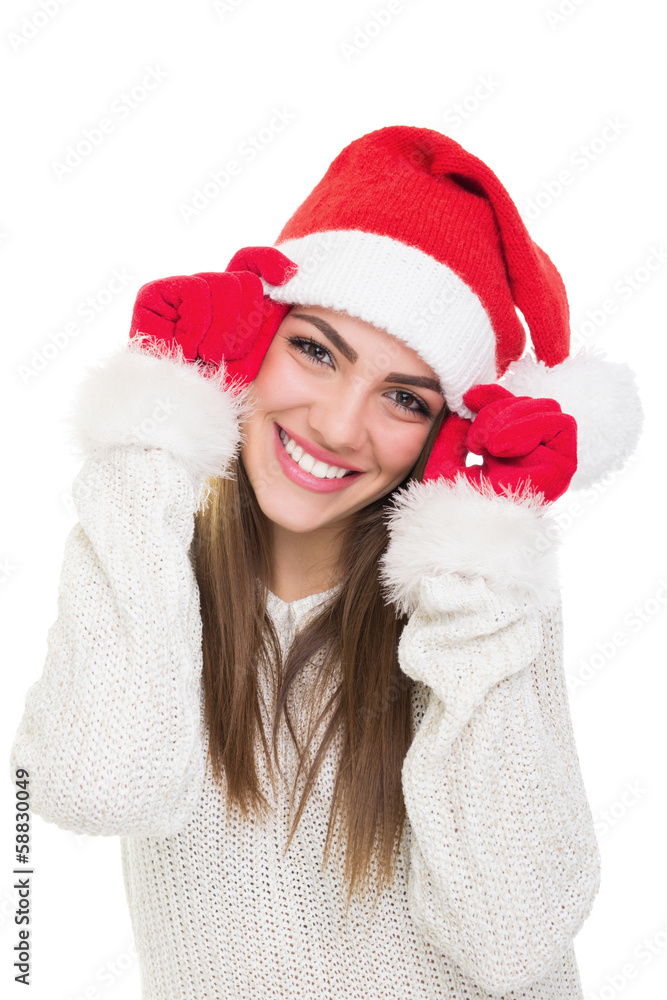 Cute teenage girl posing wearing Santa Claus hat and gloves Cute teenage girl posing wearing Santa Claus hat and gloves