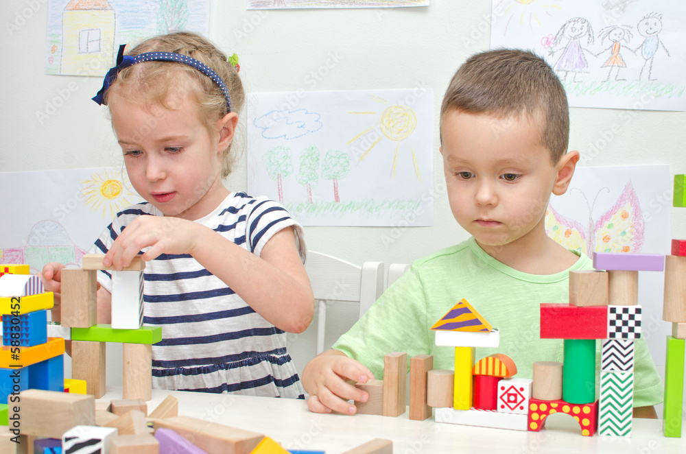 Fototapeta premium Children playing with blocks in kindergarten