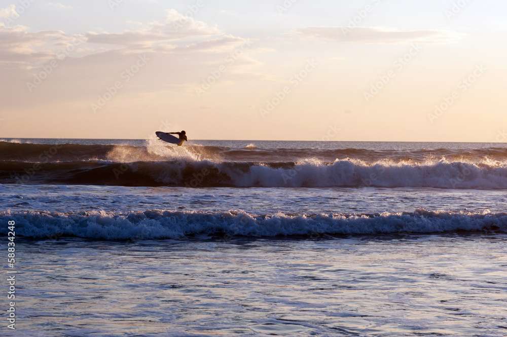 Surfer at sunset in the ocean