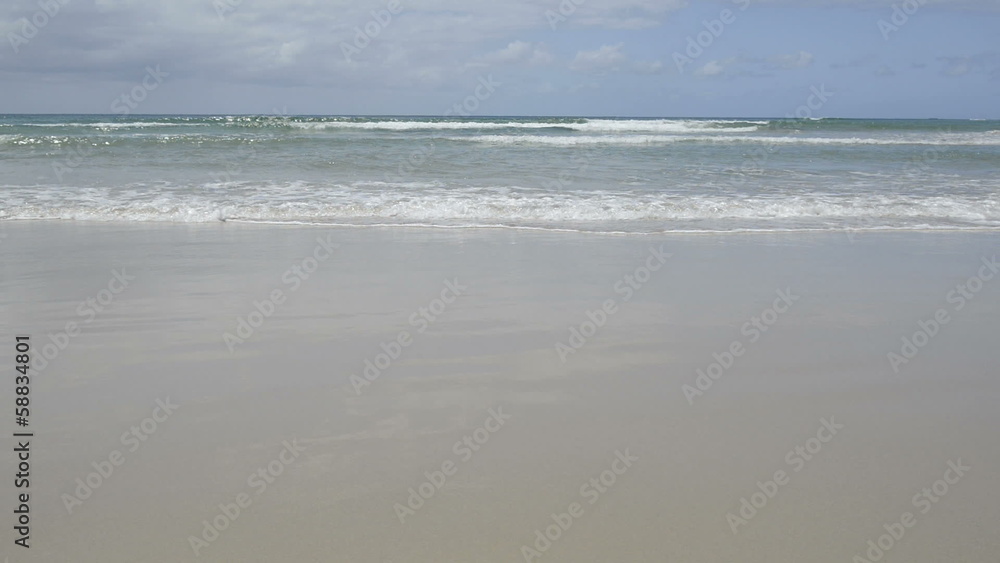 Gentle small ocean waves lapping the beach on Stradbroke Island Gentle small ocean waves lapping the beach on Stradbroke Island