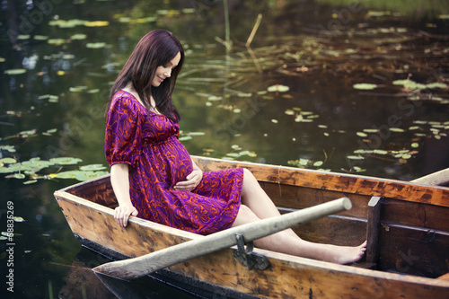 Pregnant woman sitting in boat © baltskars