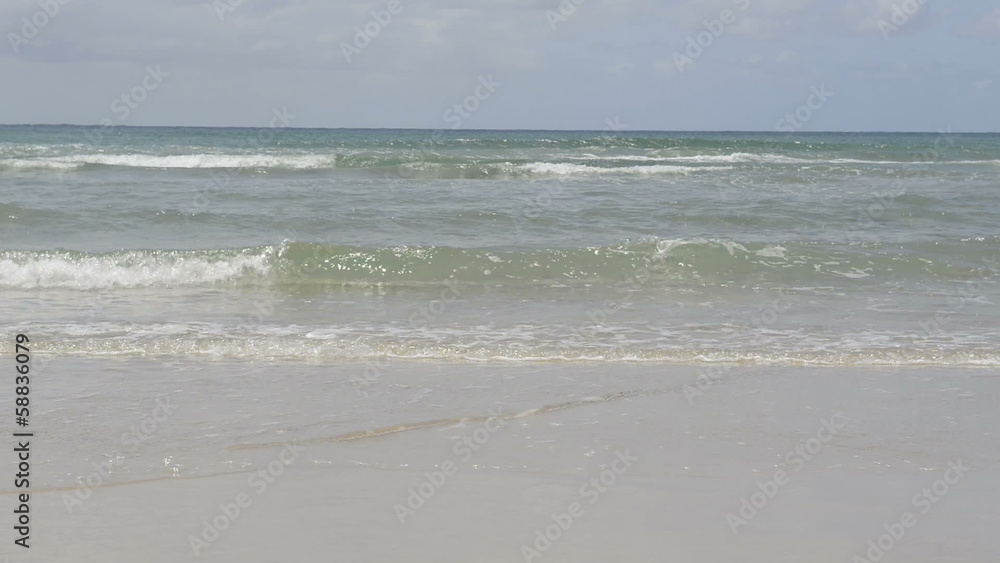 Gentle small ocean waves lapping the beach on Stradbroke Island Gentle small ocean waves lapping the beach on Stradbroke Island