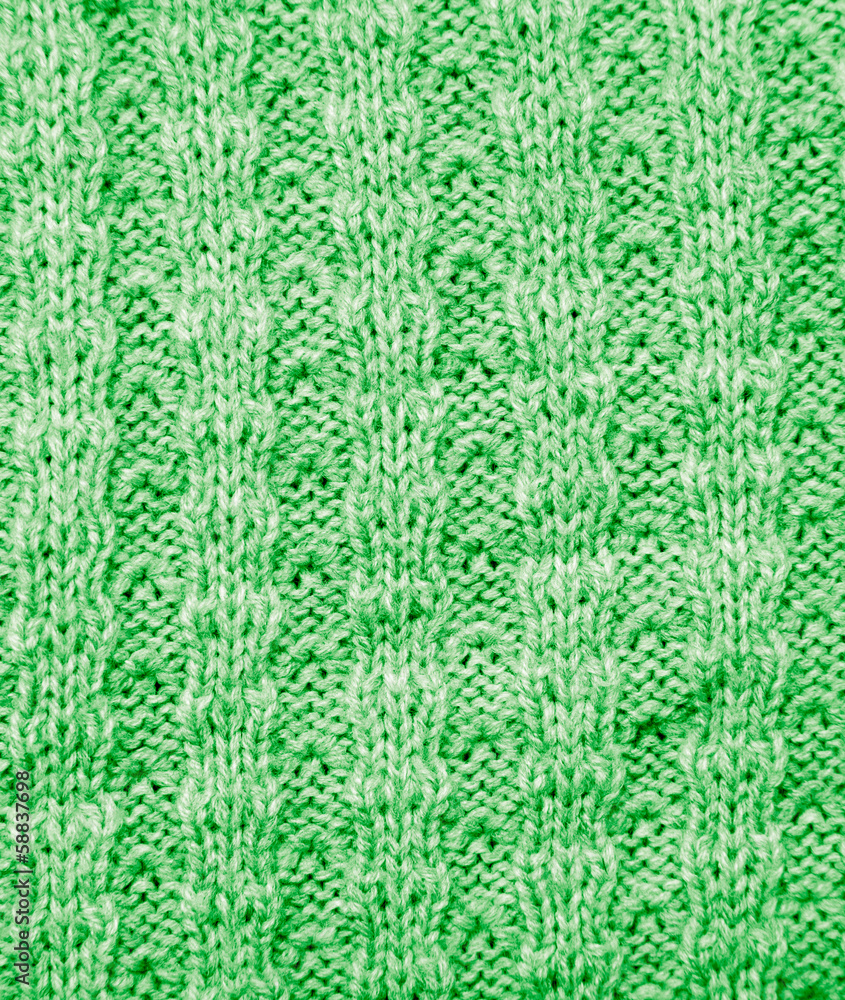 background of a green knitted fabric. texture