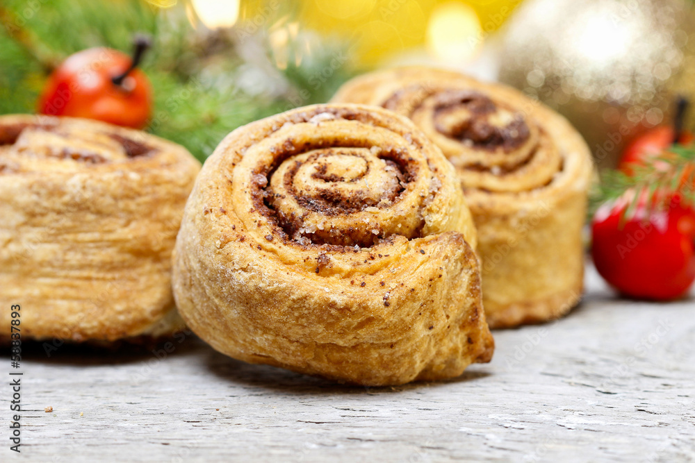 Delicious cinnamon rolls on christmas table. Selective focus Delicious cinnamon rolls on christmas table. Selective focus