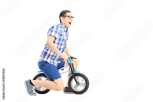 Excited guy riding a small bicycle