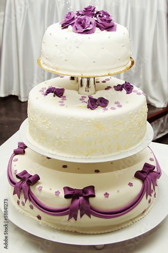 White wedding cake with purple flower detail