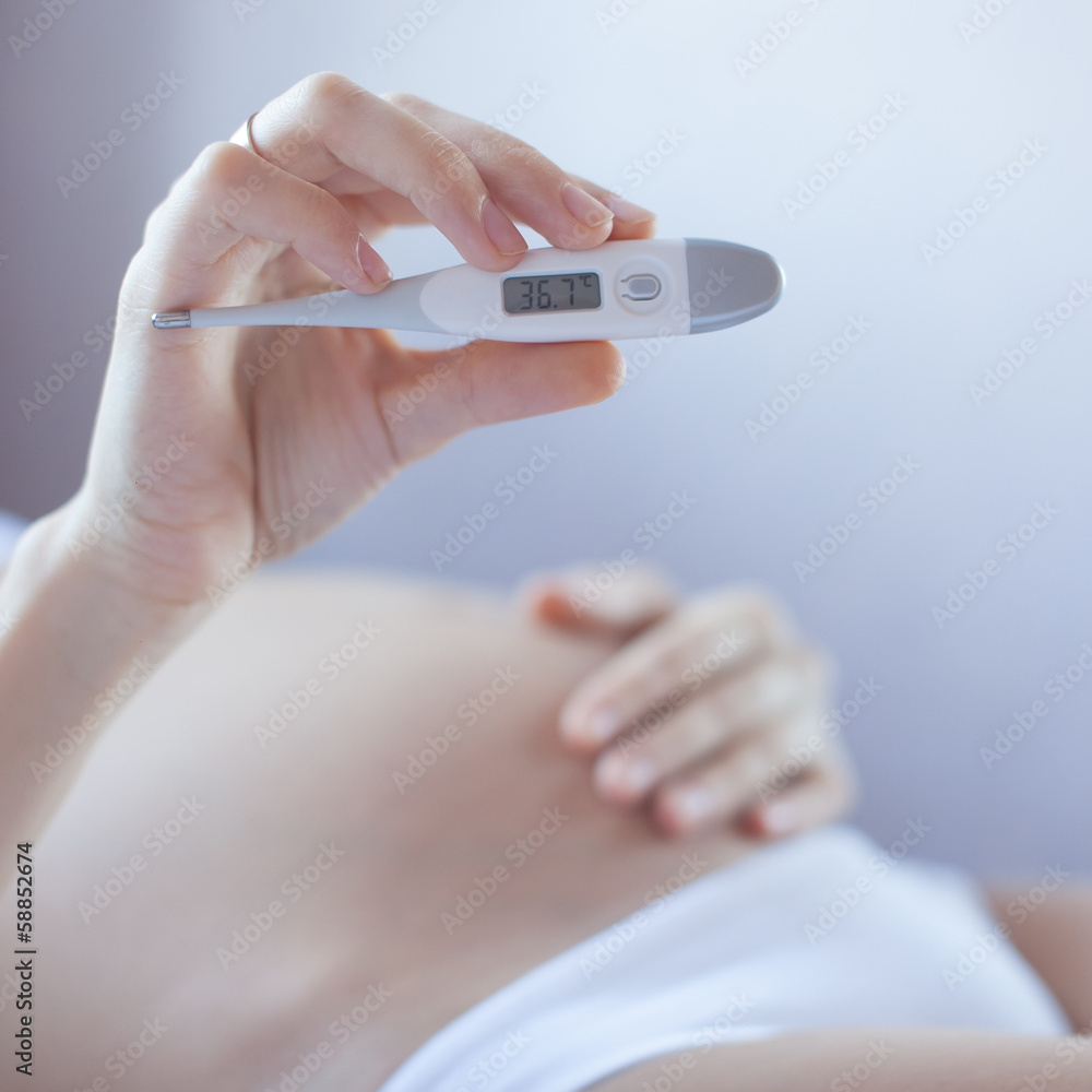 Healthy Pregnant woman showing temperature Healthy Pregnant woman showing temperature