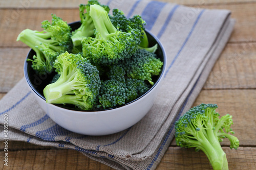 fresh broccoli in a bowl on a rustic table
