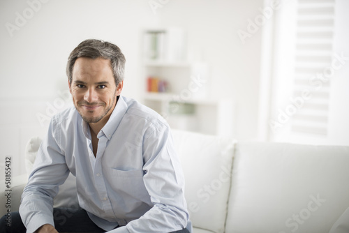 attractive man smiling on a couch