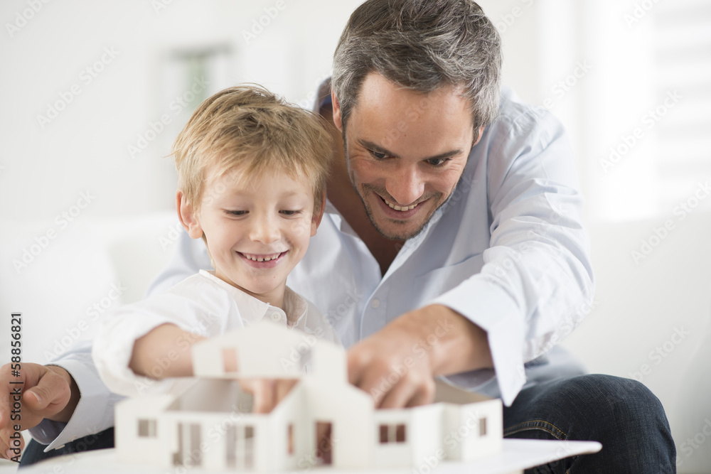 father and son building a model house father and son building a model house