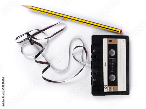 Fotografie retro cassette with loose tape over a white background