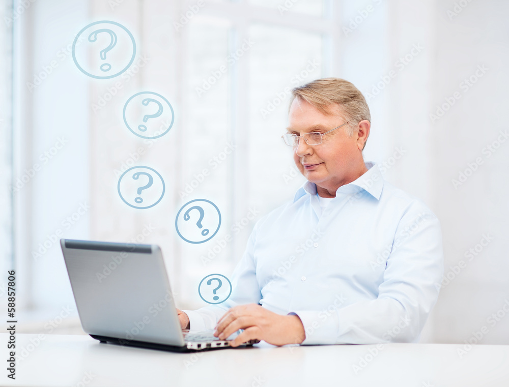 old man in eyeglasses working with laptop at home old man in eyeglasses working with laptop at home