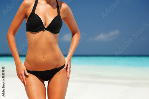 Sexy woman body on the beach background