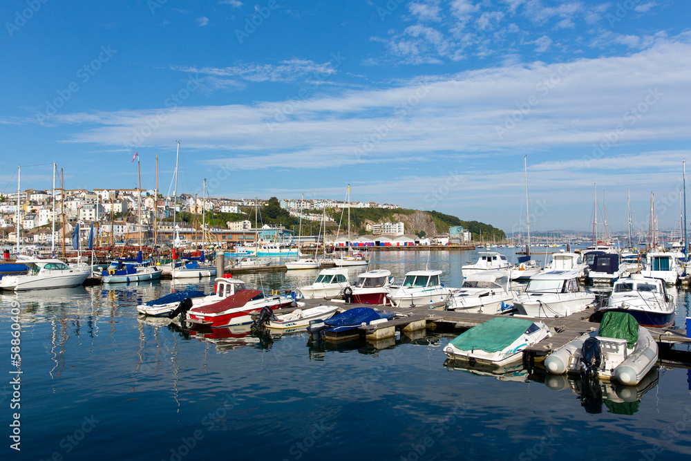 boats and yachts in marina on calm blue sea