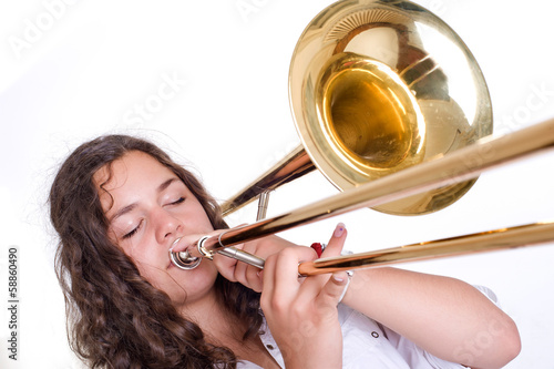 Teenage girl playing the trombone photo