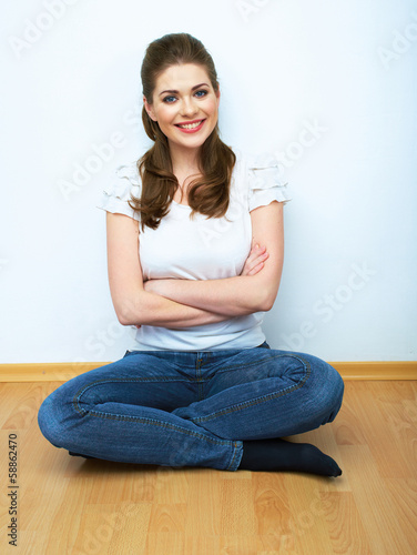 Woman natural portrait seatting on a floor. White background is