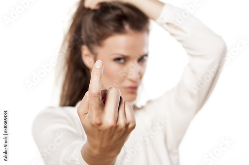 Bilde på lerret ravishing girl shows a sign with her finger to invitation