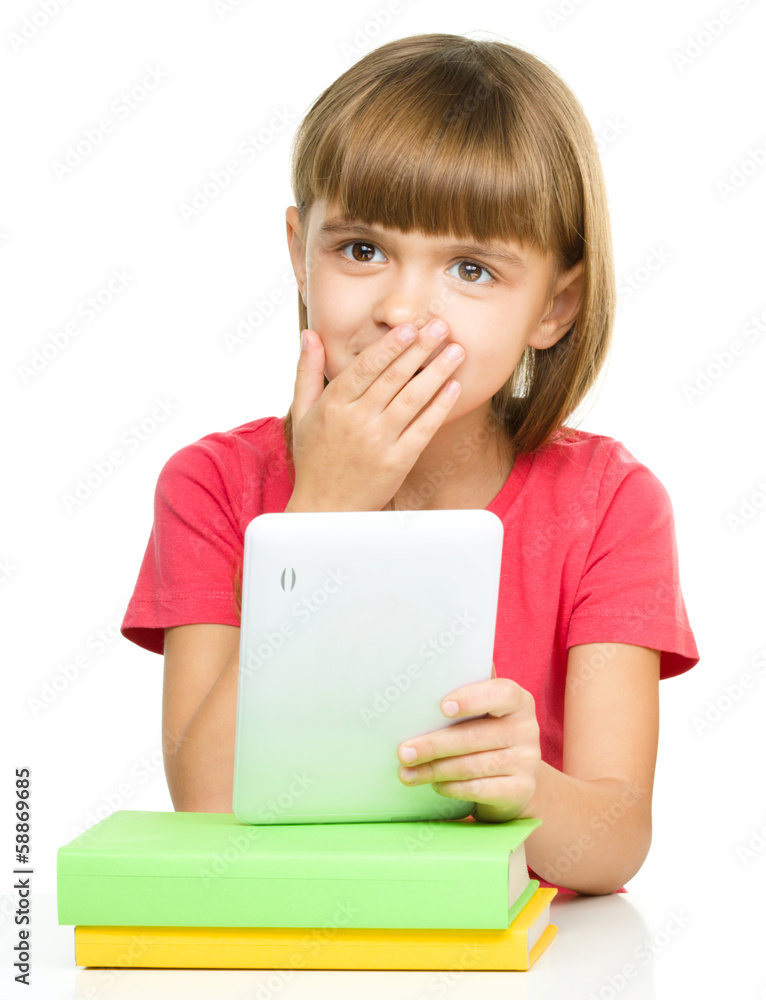 Young girl is using tablet while studying Young girl is using tablet while studying