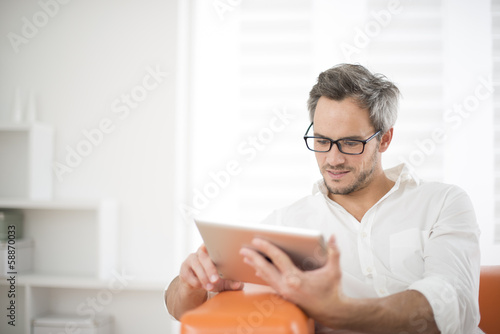 handsome man surfing on tablet