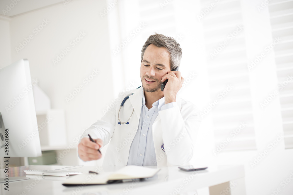 young doctor on phone at his office young doctor on phone at his office